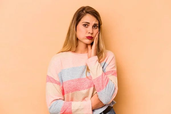 Young Caucasian Woman Isolated Beige Background Blows Cheeks Has Tired — Stock Photo, Image