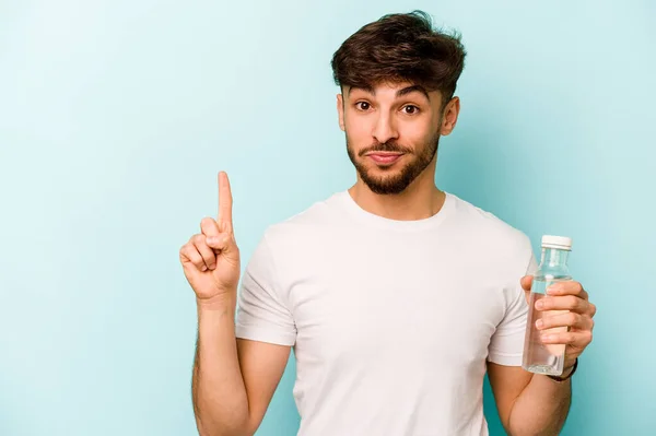 Young Hispanic Man Holding Bottle Water Isolated White Background Showing — Stockfoto