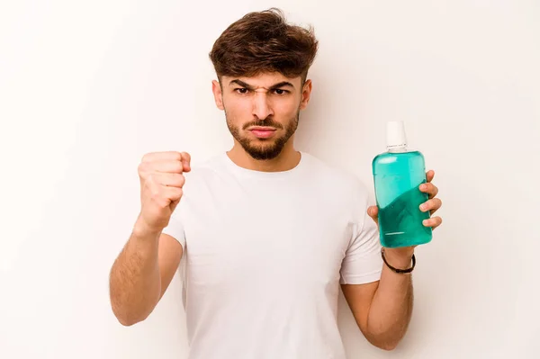 Young Hispanic Man Holding Mouthwash Isolated White Background Showing Fist — Stock fotografie