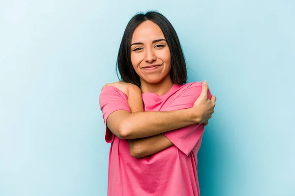 Junge Hispanische Frau Isoliert Auf Blauem Hintergrund Umarmt Lächelt Unbeschwert — Stockfoto