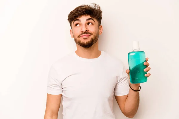 Young Hispanic Man Holding Mouthwash Isolated White Background Dreaming Achieving — Stock fotografie