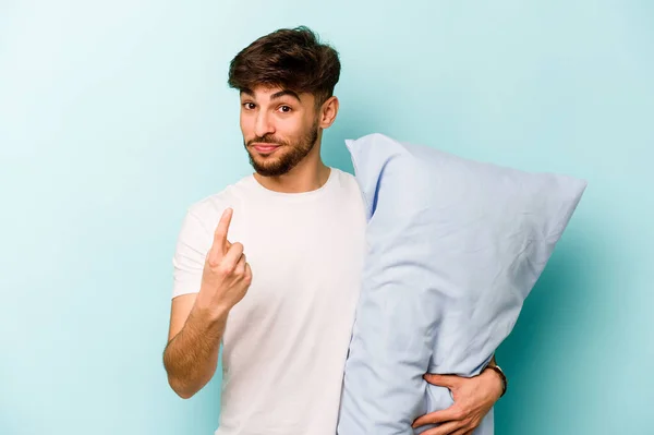 Young Hispanic Man Wearing Pajama Holding Pillow Isolated Blue Background — ストック写真