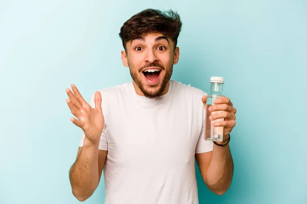 Young Hispanic Man Holding Bottle Water Isolated White Background Receiving — Stockfoto