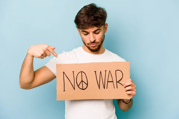 Young hispanic man holding no war placard isolated on white background