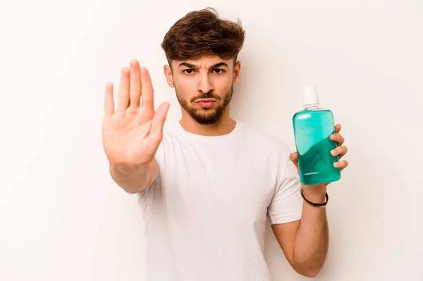 Young Hispanic Man Holding Mouthwash Isolated White Background Standing Outstretched — Stok Foto