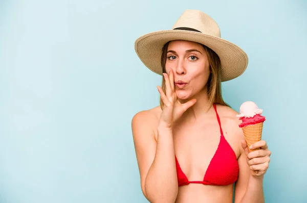 Young Caucasian Woman Wearing Bikini Holding Ice Cream Isolated Blue — Stock Photo, Image