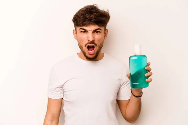 Young Hispanic Man Holding Mouthwash Isolated White Background Screaming Very — Stock fotografie