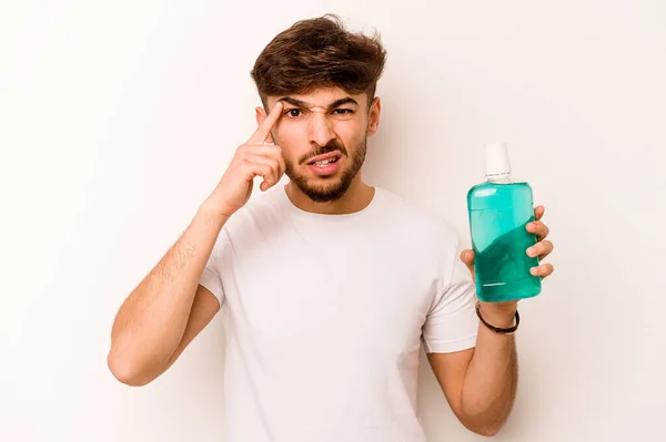 Young Hispanic Man Holding Mouthwash Isolated White Background Showing Disappointment — Stockfoto