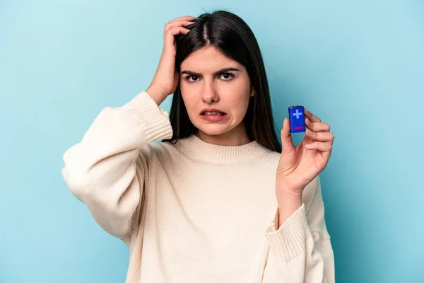 Mladá Běloška Která Drží Baterii Izolovanou Modrém Pozadí Šokována Vzpomněla — Stock fotografie