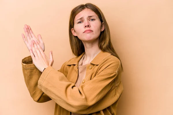 Young English woman isolated on beige background feeling energetic and comfortable, rubbing hands confident.