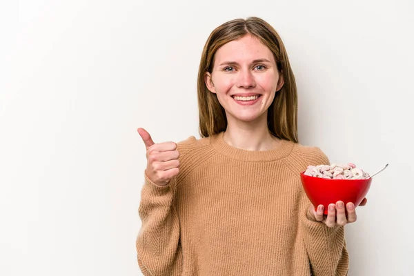 Jovem Inglesa Comendo Cereais Isolados Fundo Branco Sorrindo Levantando Polegar — Fotografia de Stock