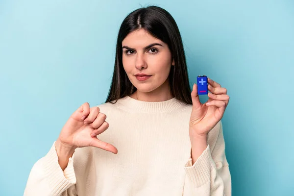 青い背景にバッテリーを隔離している若い白人女性は 嫌なジェスチャー 親指を下に示しています 意見の相違 — ストック写真