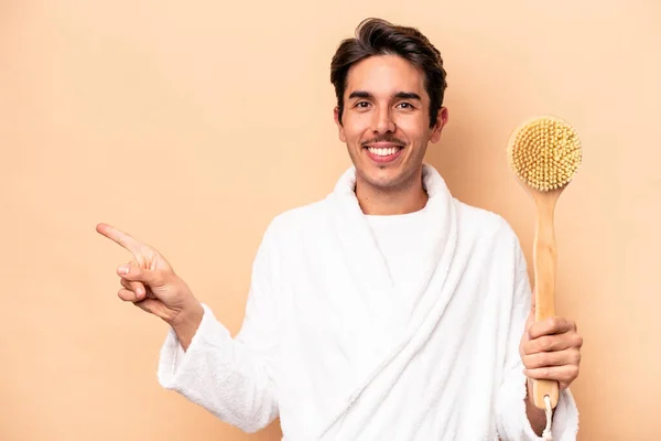 Young Caucasian Man Wearing Bathrobe Holding Back Scratcher Isolated Beige — Stock Photo, Image