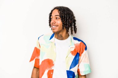 Beyaz arka planda izole edilmiş genç bir Afrikalı Amerikalı. Rahatlamış ve mutlu bir şekilde gülüyor. Dişlerini göstererek boynunu geriyor..