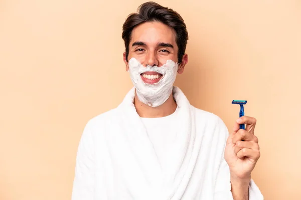 Young Caucasian Man Shaving His Beard Isolated Beige Background Happy — Stock Photo, Image