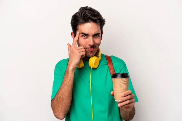 Young caucasian student man drinking coffee isolated on white background pointing temple with finger, thinking, focused on a task.