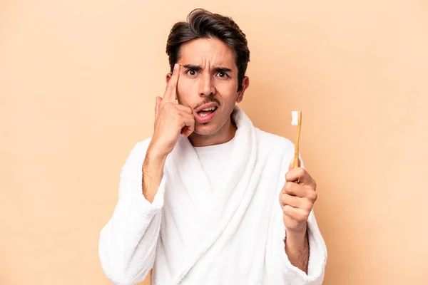 Joven Hombre Caucásico Con Albornoz Sosteniendo Cepillo Dientes Aislado Sobre —  Fotos de Stock