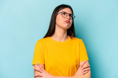 Mavi arka planda izole edilmiş genç beyaz kadın tekrarlanan bir görevden yoruldu..