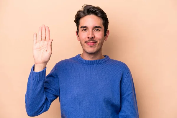 Young Caucasian Man Isolated Beige Background Smiling Cheerful Showing Number — Stock Photo, Image