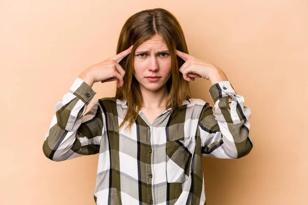 Junge Engländerin Isoliert Auf Beigem Hintergrund Konzentriert Auf Eine Aufgabe — Stockfoto