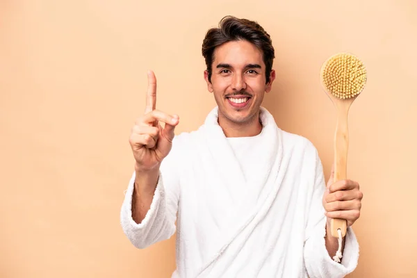 Young Caucasian Man Wearing Bathrobe Holding Back Scratcher Isolated Beige — Stock Photo, Image