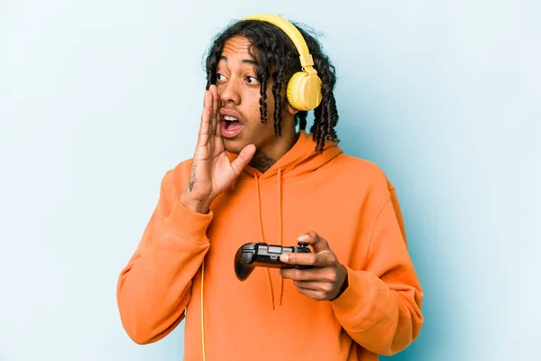 Ung Afroamerikansk Mann Som Spiller Med Videospillkontroller Isolert Blå Bakgrunn – stockfoto