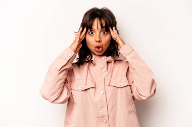 Young hispanic woman isolated on white background receiving a pleasant surprise, excited and raising hands.