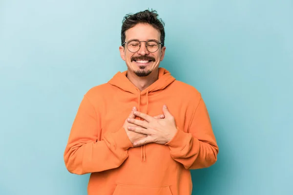 Young Caucasian Man Isolated Blue Background Laughing Keeping Hands Heart — Stock Photo, Image