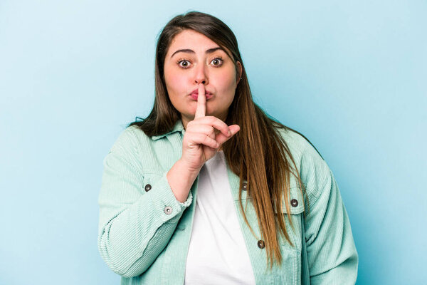 Young caucasian overweight woman isolated on blue background keeping a secret or asking for silence.