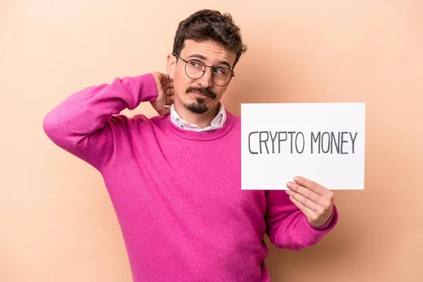 Young Caucasian Man Holding Crypto Money Placard Isolated Beige Background — Stock Photo, Image