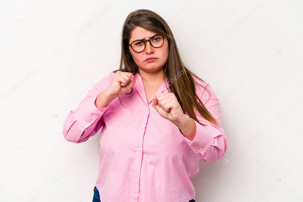Young caucasian overweight woman isolated on white background showing fist to camera, aggressive facial expression.