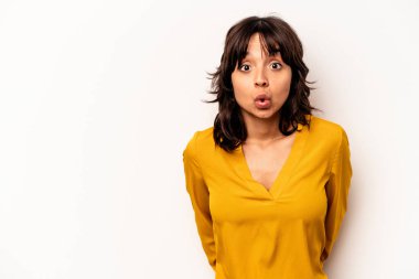 Young hispanic woman isolated on white background being shocked because of something she has seen.