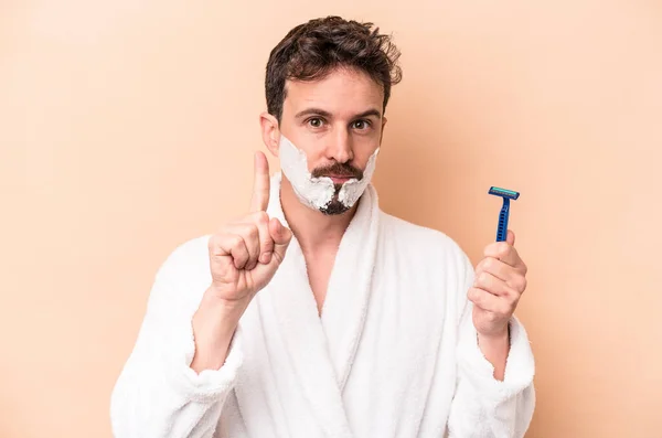 Young Caucasian Man Wearing Shaving Foam Holding Razor Blade Isolated — Stock Photo, Image