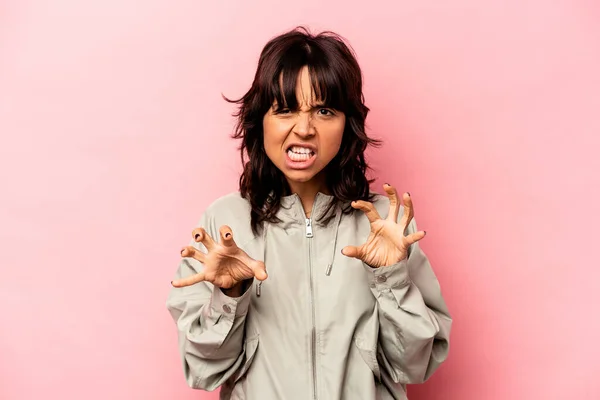 stock image Young hispanic woman isolated on pink background showing claws imitating a cat, aggressive gesture.