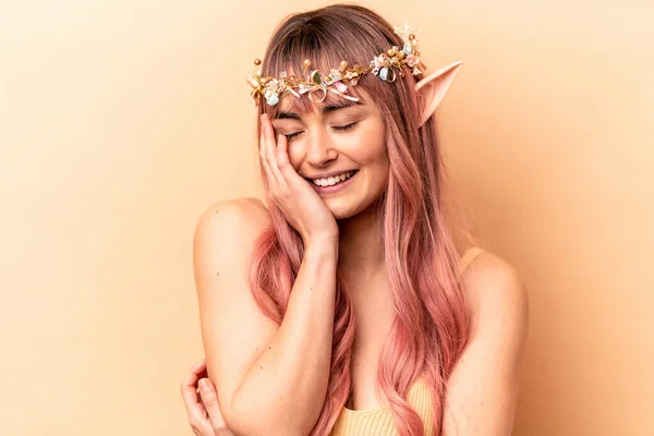 Young elf woman with pink hair isolated on beige background