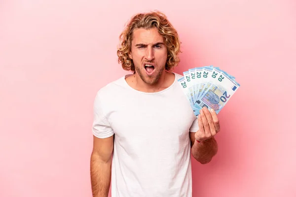 Young Caucasian Man Holding Banknotes Isolated Pink Background Screaming Very — Stockfoto
