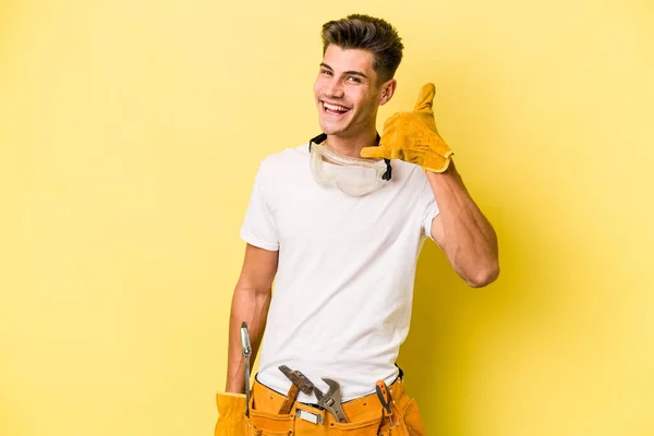 Young Electrician Caucasian Man Isolated Yellow Background Showing Mobile Phone — 스톡 사진