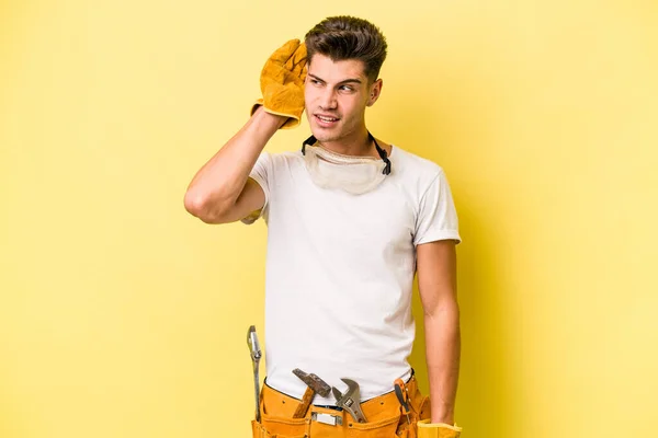 Young Electrician Caucasian Man Isolated Yellow Background Trying Listening Gossip — Stock Fotó