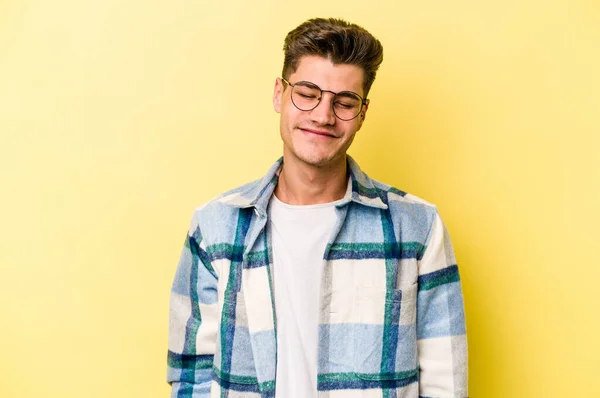 Young Caucasian Man Isolated Yellow Background Laughs Closes Eyes Feels — Stock Photo, Image
