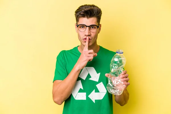 Young Caucasian Man Holding Bottle Plastic Recycle Isolated Yellow Background — Stock Photo, Image