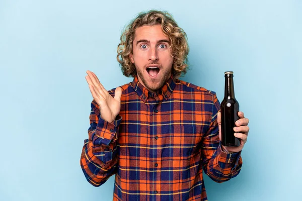Jonge Blanke Man Houdt Bier Geïsoleerd Witte Achtergrond Verrast Geschokt — Stockfoto