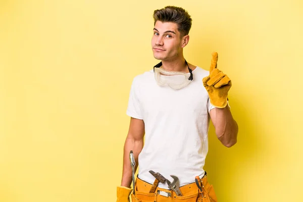 Young Electrician Caucasian Man Isolated Yellow Background Showing Number One — Fotografia de Stock