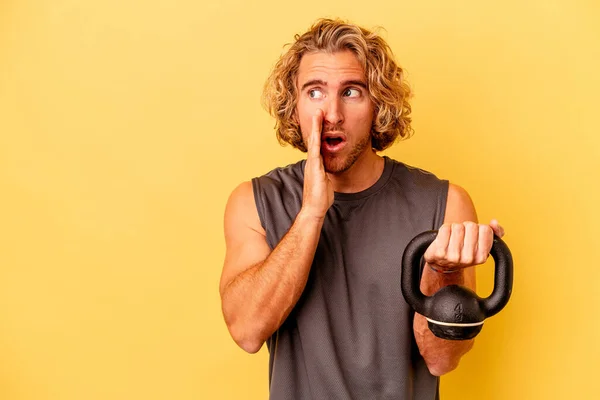 Young Sport Man Making Weightlifting Isolated Yellow Background Saying Secret — Stockfoto