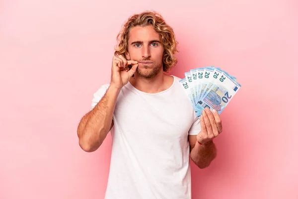 Young Caucasian Man Holding Banknotes Isolated Pink Background Fingers Lips — Stockfoto