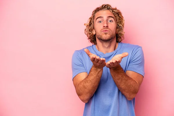 Jonge Blanke Man Geïsoleerd Roze Achtergrond Vouwen Lippen Handpalmen Lucht — Stockfoto