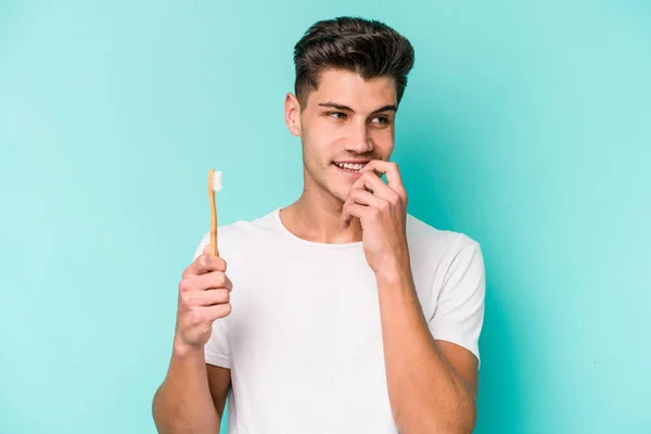 Young Caucasian Man Brushing Teeth Isolated White Background Relaxed Thinking — 스톡 사진