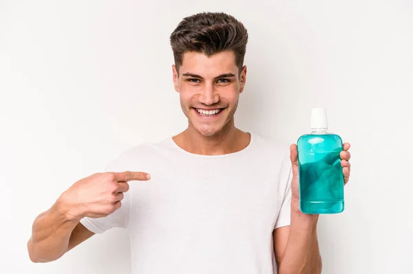 Young Caucasian Man Holding Mouthwash Isolated White Background Person Pointing — 스톡 사진