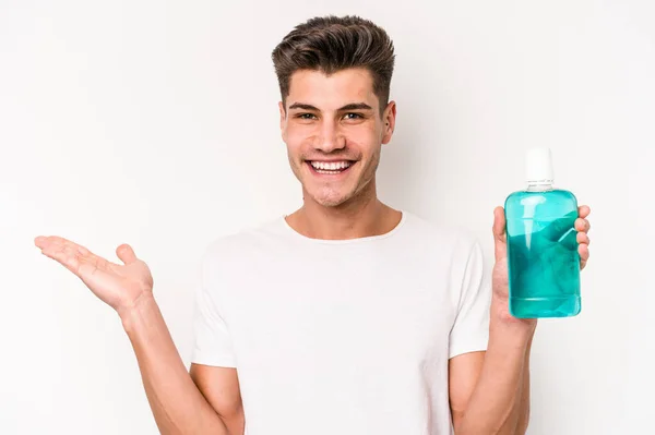 Young Caucasian Man Holding Mouthwash Isolated White Background Showing Copy — Stock fotografie