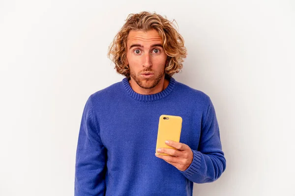 Young Caucasian Man Holding Mobile Phone Isolated White Background Shrugs — Photo