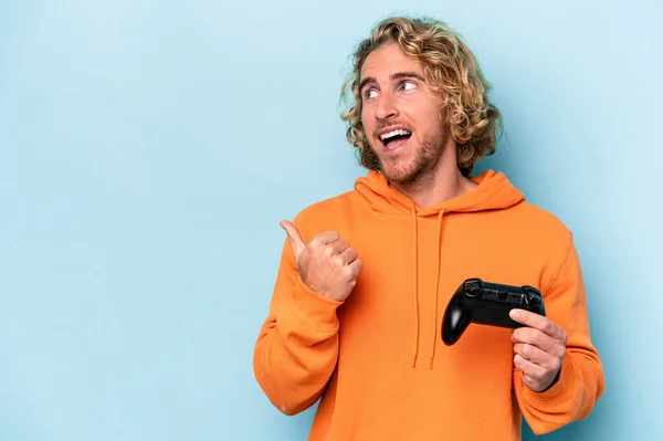 Young Caucasian Man Playing Video Game Controller Isolated Blue Background — Stockfoto